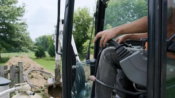 Person Operating Hand Controlling the Joystick of Excavator alt