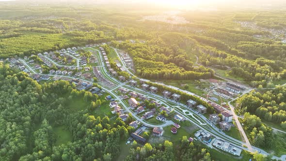 Small modern village in summer at sunset. Aerial view