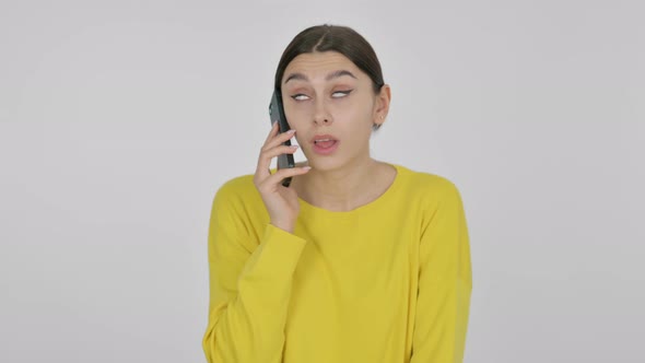 Angry Spanish Woman Talking on Phone on White Background