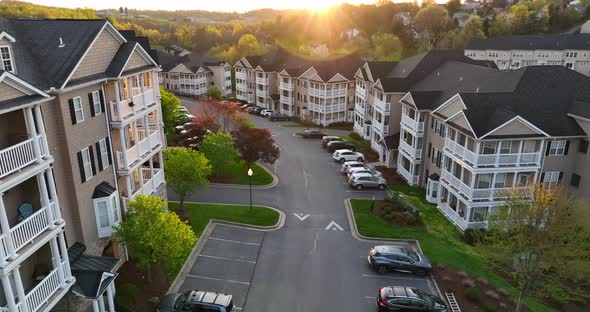 Cinematic aerial of residential apartment building USA at sunrise. New modern housing construction i