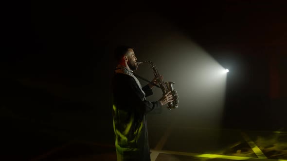 Live Performance of Saxophonist Man with Saxophone Dancing on Concert Musician Stage with Lights