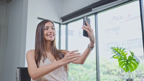 Caucasian woman customer take photo by mobile phone after change hair style at beauty salon.