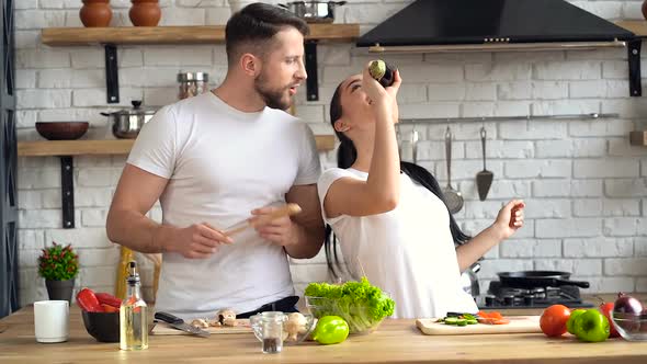 Couple having fun together at the kitchen
