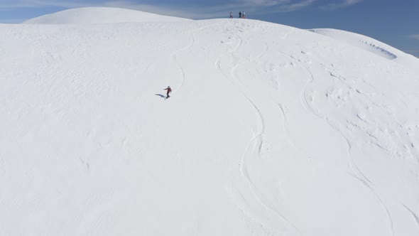 Aerial Top View Snowboarder Girl Riding Freeride Snowy Slope in Winter Mountain