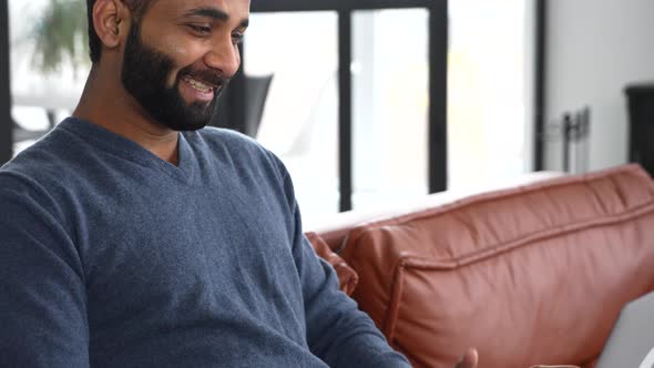 Handsome Bearded Indian Guy Using Laptop for Video Connection