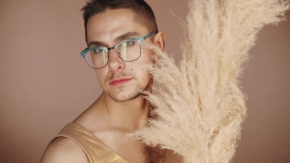 Fancy Gay Man Posing for Camera with Pampas Grass