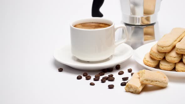 White Ceramic Cup of Coffee with a Savoiardi Ladyfinger Cookie on a Plate