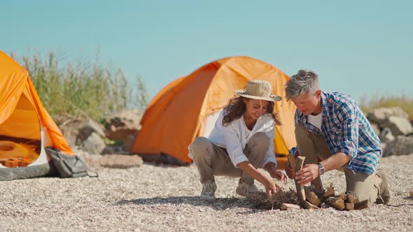 Couple Preparing Campfire Together