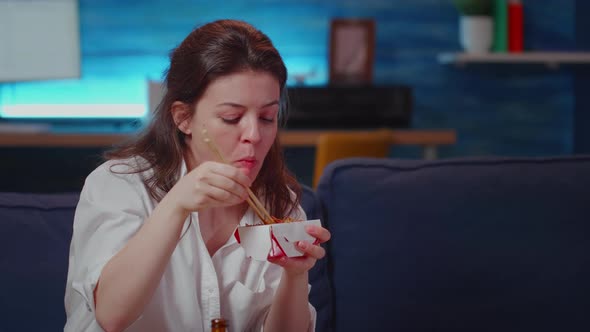 Close Up of Business Woman Eating Asian Food at TV