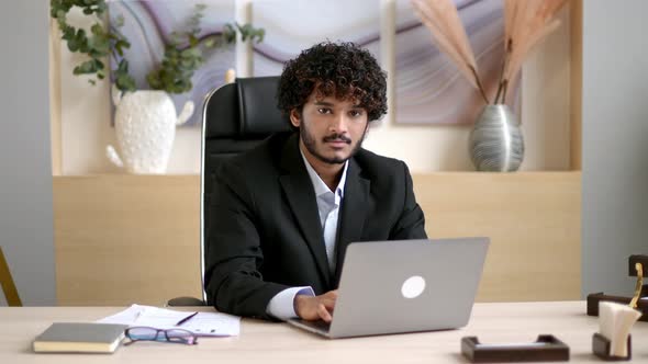 Positive Charismatic Intelligent Curlyhaired Young Adult Indian or Arabian Businessman Wearing