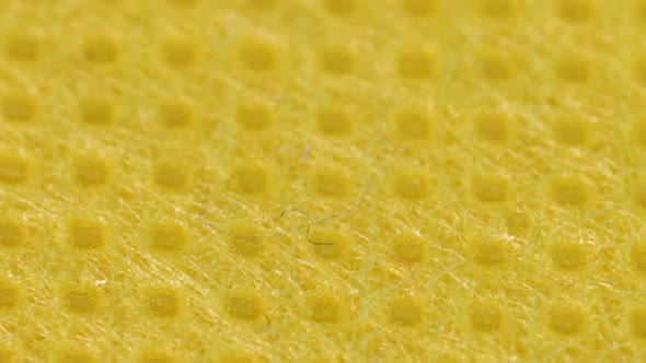 Yellow textile cloth surface texture, macro shot close up view with rotation motion.