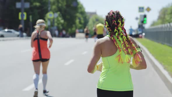 Woman with Braids Running Street Race