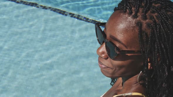 Beautiful Black Woman Sitting Poolside