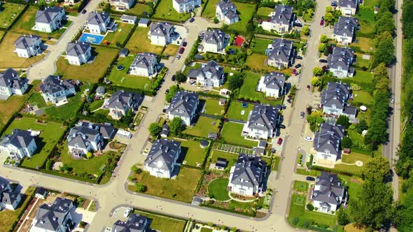 Street with new homes in spring season. Single family houses and residential construction planned co