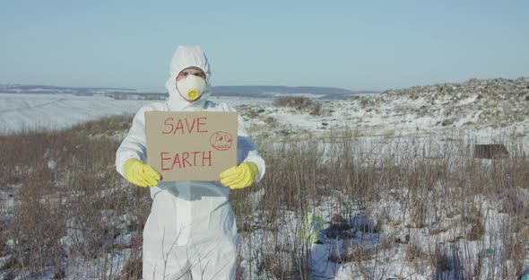 Man Wore in Protective Suit Show Protest Sign "Save Earth" at Plastic Pollution
