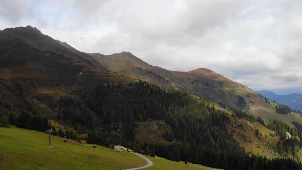 Ski Lifts With Alpine Mountains At Rauris Valley Ski Area In Pinzgau, Austria. Aerial Tilt-Down