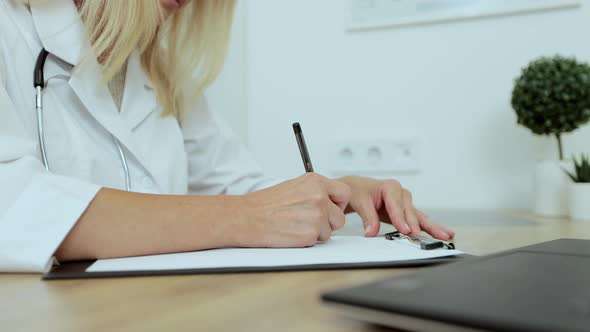 Close Up Female Doctor Writing Notes in Registration Album Managing Patients Appointments at