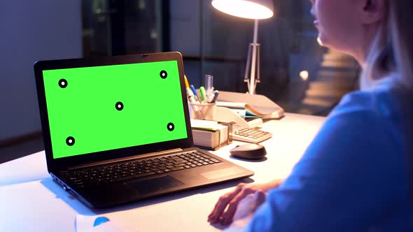 Businesswoman with Green Screen on Laptop at Night 7