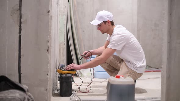 Electrician checks the voltage in the mains