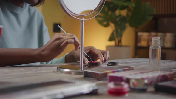 A Beautiful Lady is Drawing Halloween Makeup