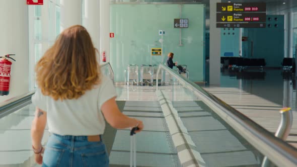 Young Millennial Traveler Woman in Empty Airport