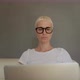 Blonde woman in glasses on sofa with laptop - VideoHive Item for Sale