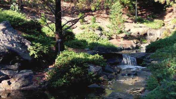 Tranquil waterfall flows into pond