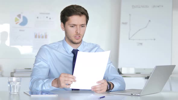 Businessman Upset after Reading Documents