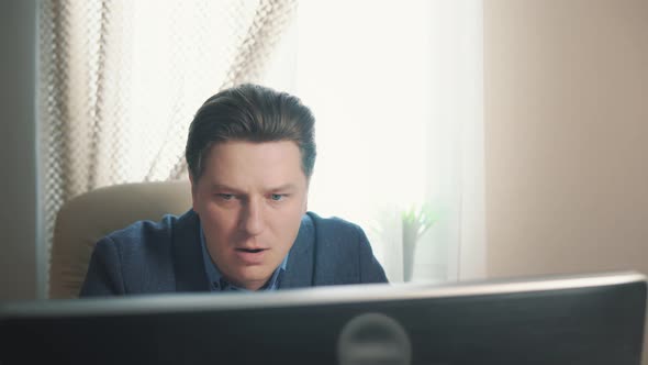 Angry Man Screaming While Working at the Computer