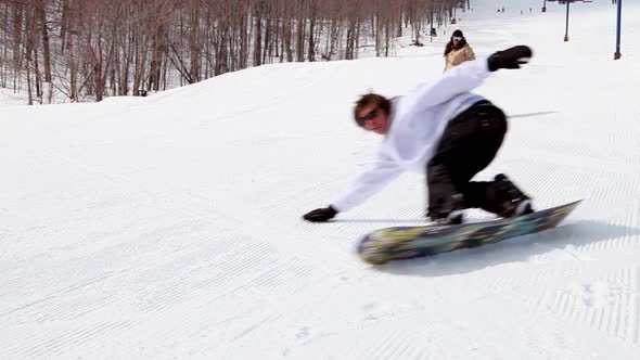 Two people snowboarding downhill