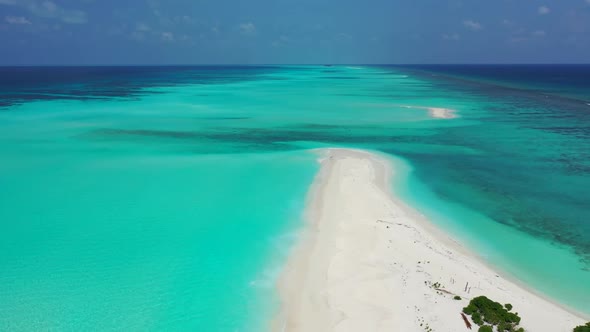 Aerial flying over landscape of perfect coast beach wildlife by blue lagoon and white sand backgroun