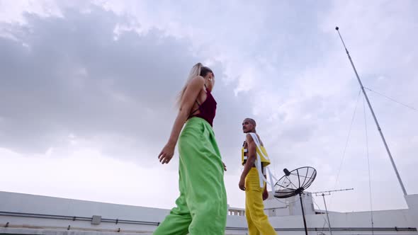 Dancers In Clubwear Dancing And Performing Together On Skyscraper