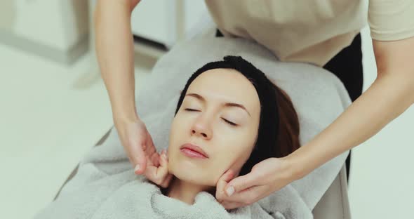 Woman Receiving a Facial Massage