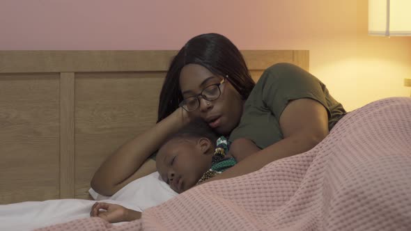 Portrait of smiling business black African american woman, a mom with her daughter lull the child