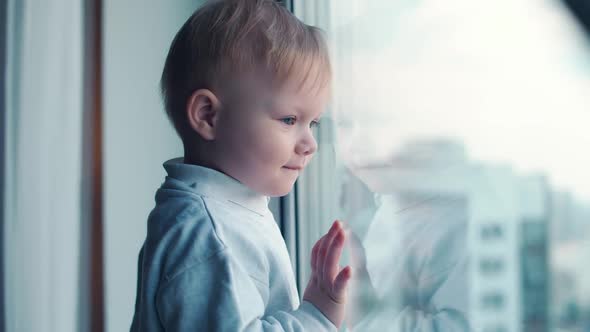 Childhood During Lockdown a Little Kid on Home Quarantine Looking Out the Window Selfisolation in