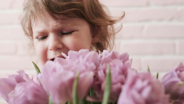 Portrait Of A Kid With A Bouquet Of Flowers In His Hands. Sorrow. Close-up.