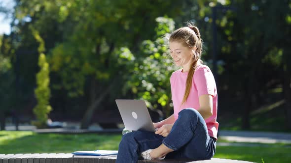 Woman Having Video Call Via Laptop in Park