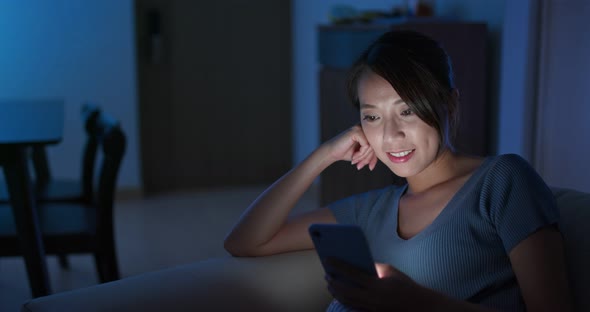 Woman look at  mobile phone at night