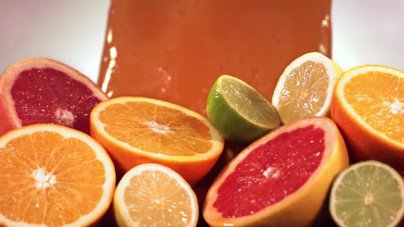 Slow Motion Shot of Citrus Fruits and Juice Splashing Through Lemon Lime Grapefruit Slices