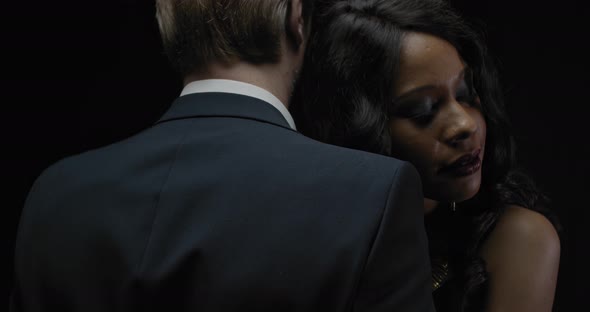 Elegant Couple Young Black Woman Is Hugging a Man in a Suit