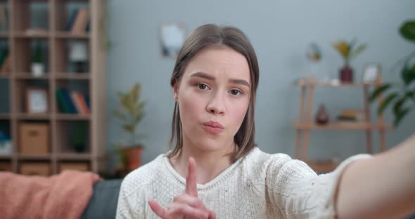Millennial Woman Having Video Call and Showing with Sign Language Phrase Terrible News. Female