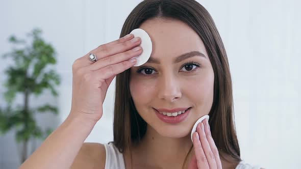 Attractive Young Woman Using Cotton Pads