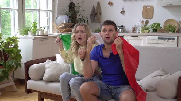 Family Couple of Sports Fans at Home with Flag of Italy