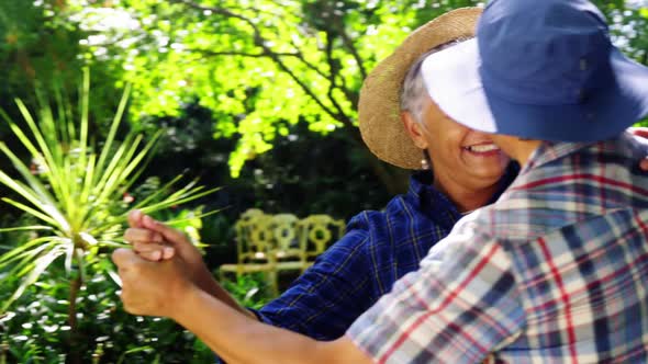 Senior couple dancing in the garden