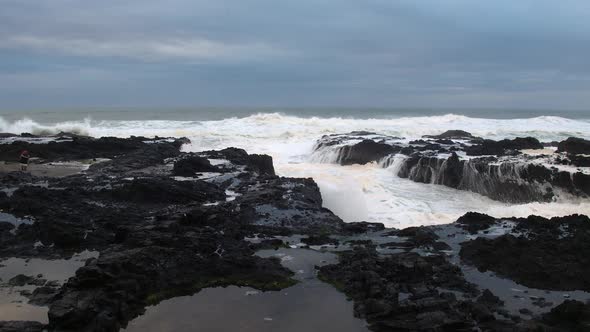 Flying through mist of wave as is crashing into rocks on Oregon Coast.