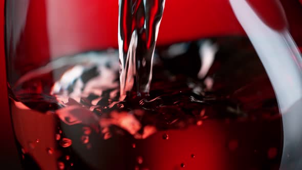 Super Slow Motion Detail Shot of Pouring Red Wine Into Glass at 1000Fps.