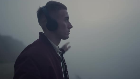 Inspired Man Dancing Headphones on Beach