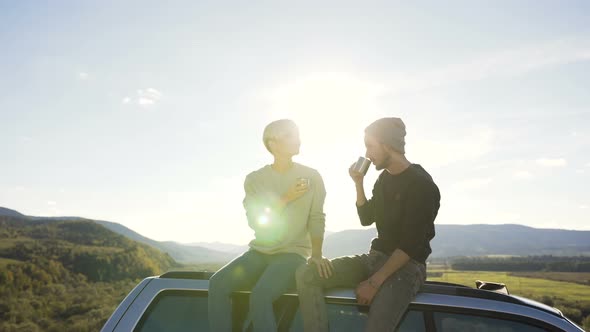 Beautiful Couple Relaxing in the Mountain with Cup of Tea