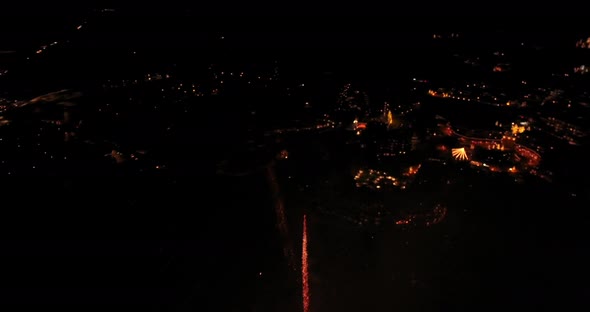 Aerial of fireworks celebration above ski resort. Sounds of fireworks and ambience added.