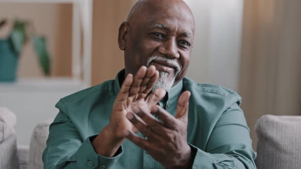 Male Portrait Indoors Elderly African American Bald Man with Gray Beard Applauds Congratulating